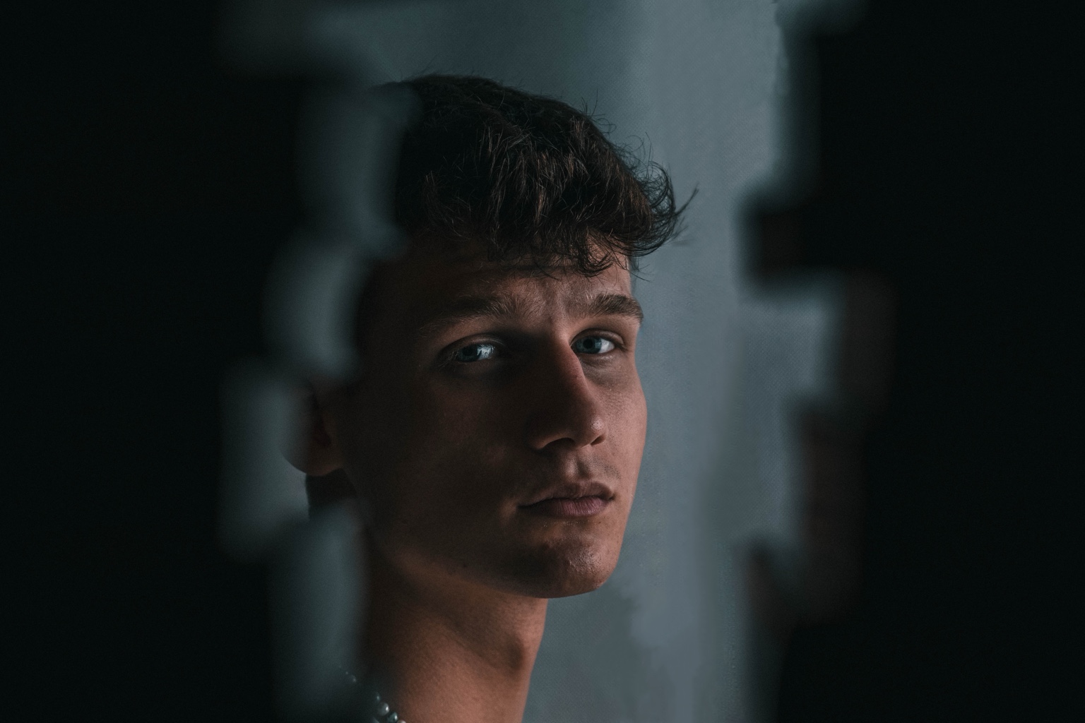 Close portrait of Noah Locher with dramatic light